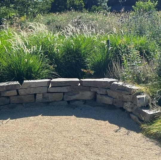 Photo of a boulder retaining wall built by Grandiflora